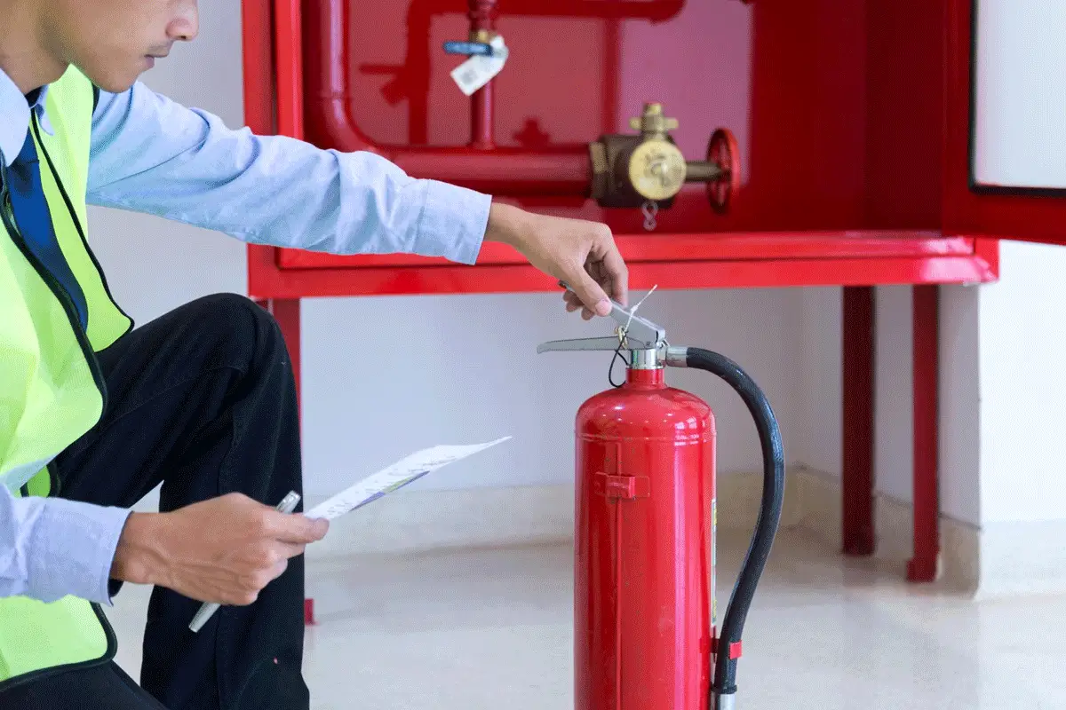 Fire extinguisher being checked by a certified person